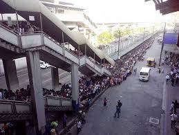 Queues going down the road as far as the eye can see are examples of some challenges the Philippines government face with an ever growing population.